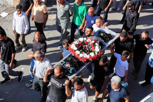 Relatives carry the body of a young girl