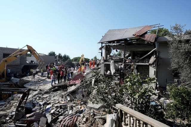 Emergency workers arrive at the scene of an Israeli airstrike in the town of Maisara, Lebanon