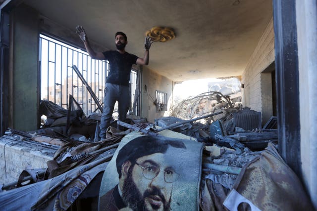 A man reacts in a damaged apartment at the site of an Israeli air strike in Saksakieh, south Lebanon