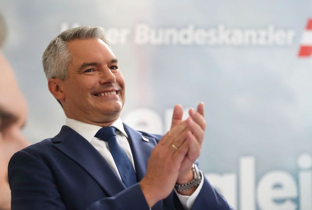 Austrian Chancellor Karl Nehammer claps his hands