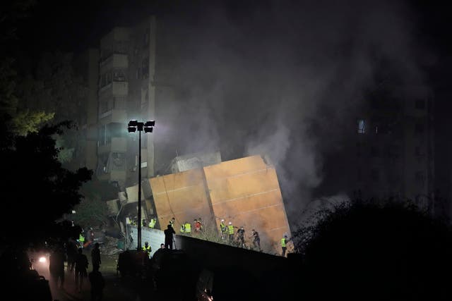 Rescuers at the site of an Israeli air strike in Beirut’s southern suburbs