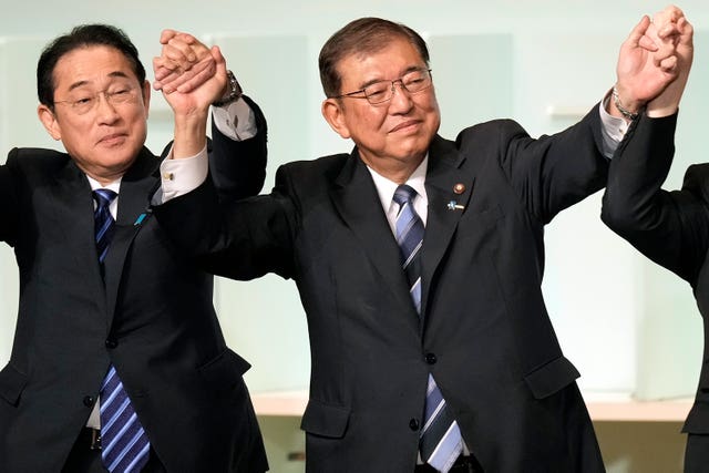 Shigeru Ishiba, right, with Japan’s Prime Minister Fumio Kishida, left, and other candidates, celebrates after Mr Ishiba was elected as new head of Japan’s ruling Liberal Democratic Party during its leadership election in Tokyo