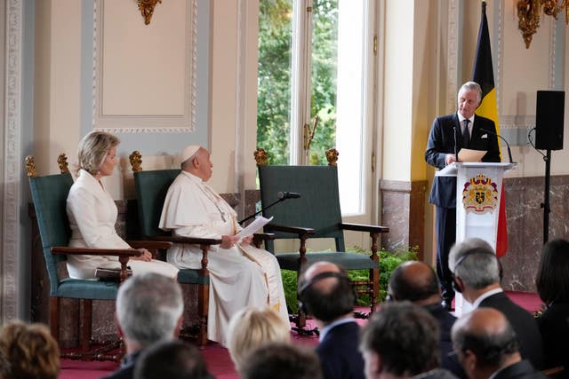 Pope Francis listens to King Philippe’s address during a meeting with the authorities and the civil society in the Grande Galerie of the Castle of Laeken, Brussels