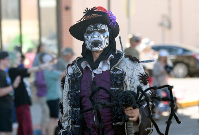 A man with fake spider dressed up for the Tarantula Festival parade