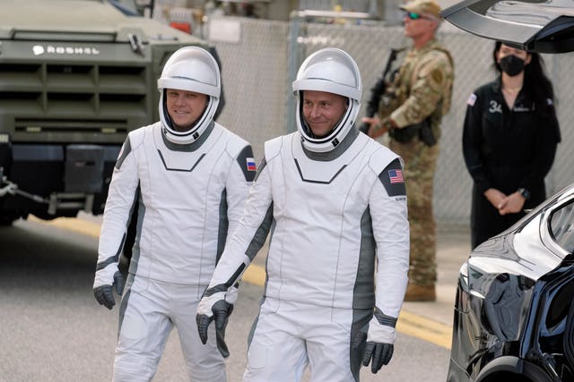 Nick Hague (right) and Aleksandr Gorbunov leave for their flight into space