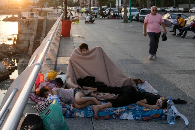 Families sleep on Beirut’s corniche after fleeing the Israeli airstrikes in Beirut’s southern suburb