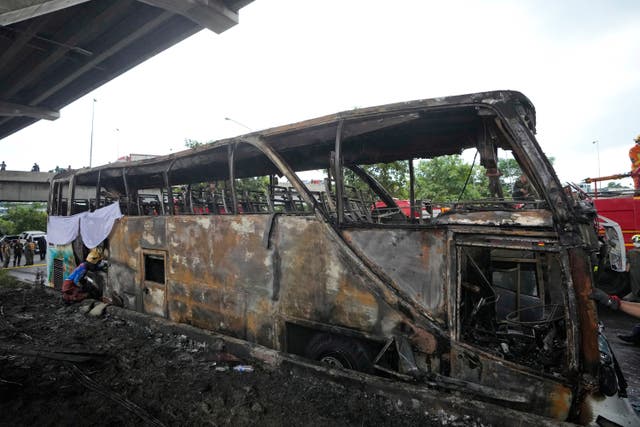 A rescuer inspects the bus 