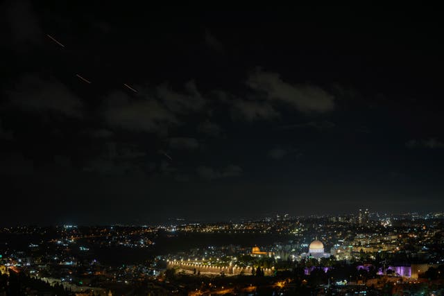 Projectiles fly through the sky over Jerusalem as a siren sounds a warning of incoming missiles fired from Iran, in Jerusalem, on Tuesday 