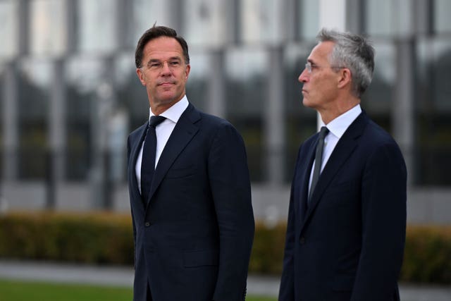 Incoming Nato Secretary General Mark Rutte, left, and outgoing Nato Secretary General Jens Stoltenberg stand during a wreath-laying ceremony at Nato headquarters in Brussels, Belgium 