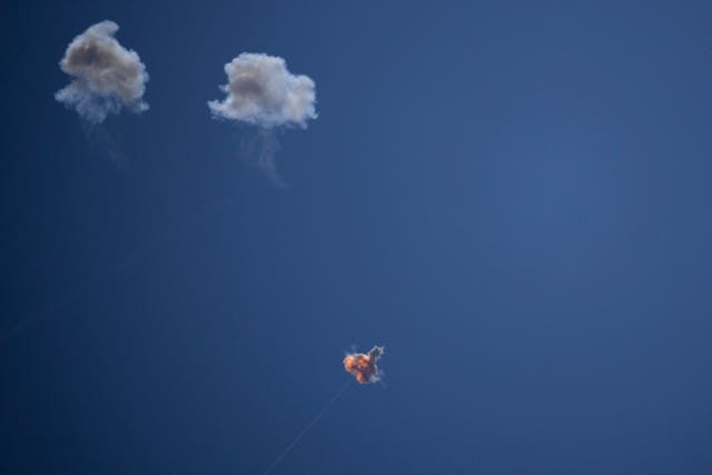 IIsraeli Iron Dome air defence system fires to intercept rockets that were launched from Lebanon  leaving puffs of smoke against a blue sky 