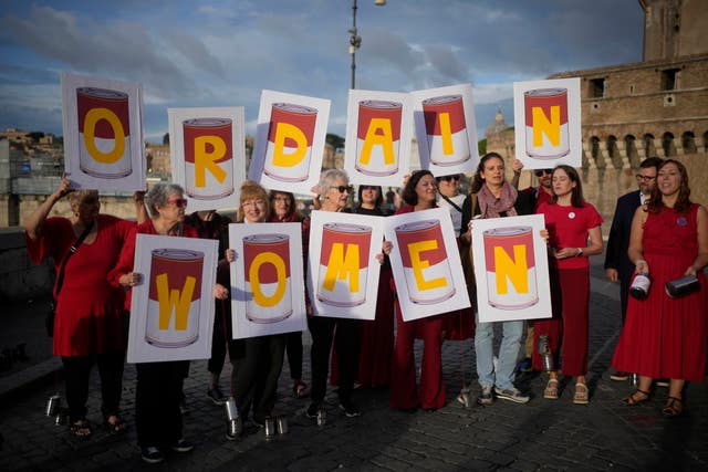 Advocates for women ordination show a banner saying: 'Don’t kick the Can, Women Can Be Priests' flash mob in Rome