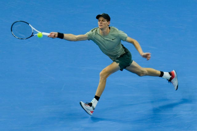 Jannik Sinner stretches for a forehand