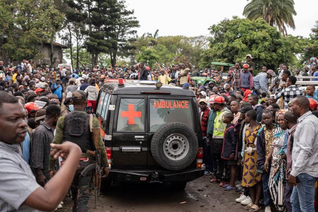 People surrounding an ambulance