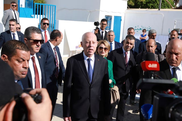 Tunisian President and candidate for re-election Kais Saied and his wife outside a polling station in Tunis 