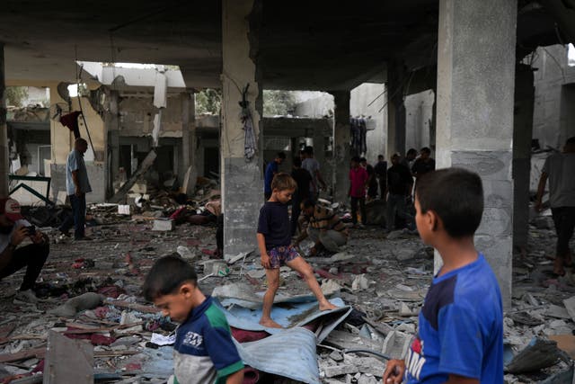 Palestinians examine a destroyed mosque following an Israeli airstrike in Deir al-Balah on Sunday 