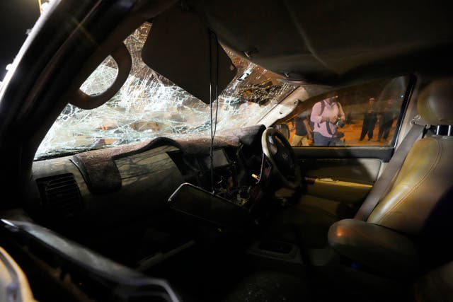 A car is wrecked after an explosion in Karachi