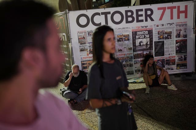 People visit a memorial in Tel Aviv