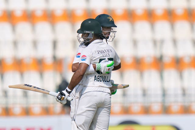 Shan Masood and Abdullah Shafique hug in the middle of the pitch