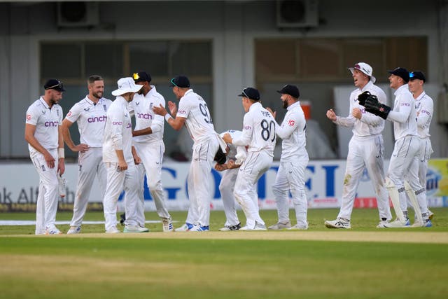 Chris Woakes, second left, and his England team-mates celebrate after third umpire give out to Pakistan’s Babar Azam 