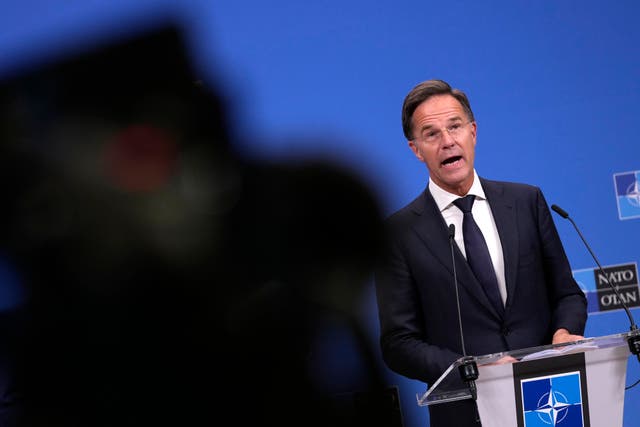 Mark Rutte speaks from a lectern bearing the Nato badge