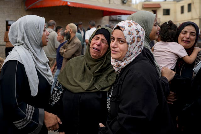 Palestinians mourn their relatives killed in the Israeli bombardment of the Gaza Strip at a hospital in Deir al-Balah