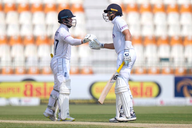 Ben Duckett (left) and Joe Root bump fists to celebrate their century partnership 