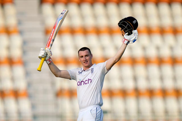 Harry Brook holds his bat and helmet aloft to celebrate his century