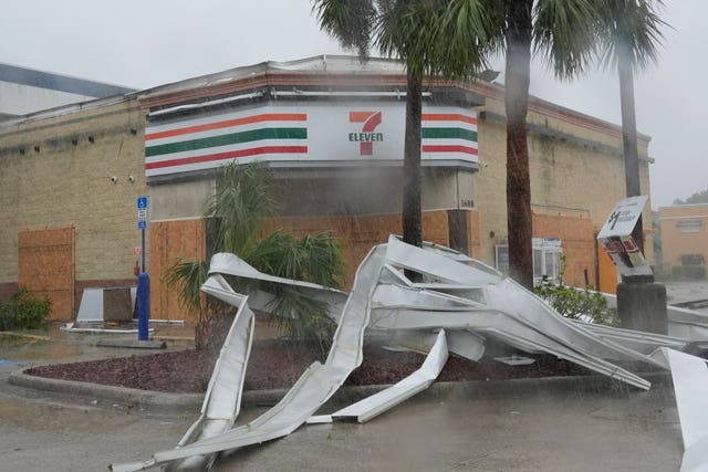 An apparent tornado caused by Hurricane Milton tore the awning off a 7-Eleven convenient store in Cape Coral 