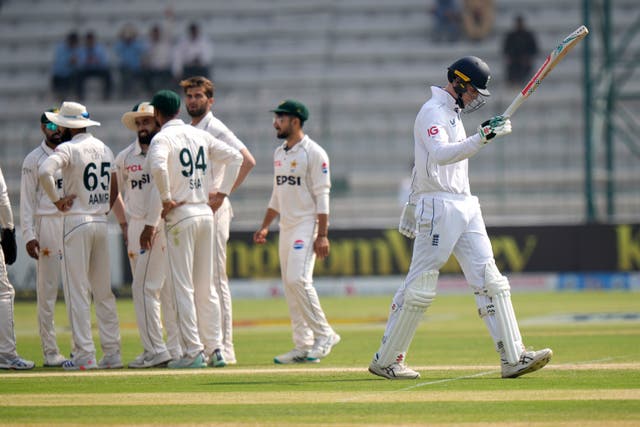 Zak Crawley, right, reacts as he walks off the field after being dismissed for 78