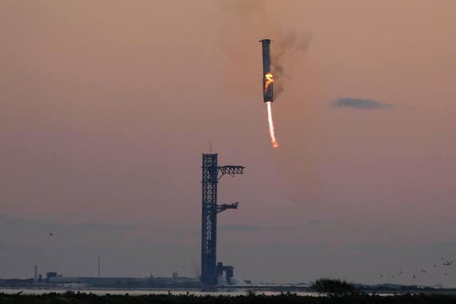 SpaceX’s mega rocket booster returning to the launch pad to be captured during a test flight