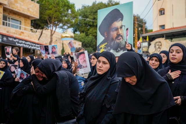 Mourners carry a picture of Hezbollah leader Hassan Nasrallah