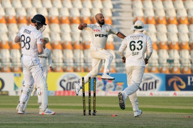 England’s Harry Brook, left, looks at his wickets after he was bowled by Sajid Khan