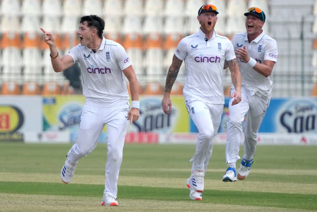 Matthew Potts, left, celebrates after taking the wicket of Salman Ali Agha