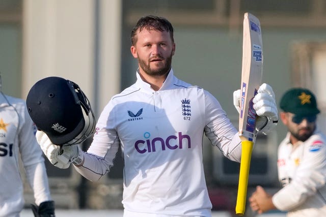 Ben Duckett raises his bat and helmet in celebration