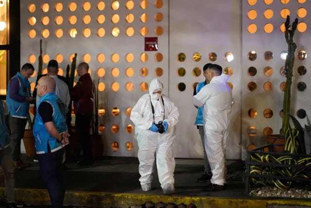 Forensic investigators leave a hotel in Buenos Aires