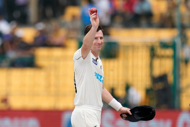 New Zealand paceman Matt Henry holds up the ball after taking five wickets against India