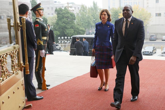 Britain’s Foreign Secretary David Lammy, right, and British Ambassador to China Caroline Wilson arrive to the Great Hall of the People in Beijing Friday, Oct. 18, 2024