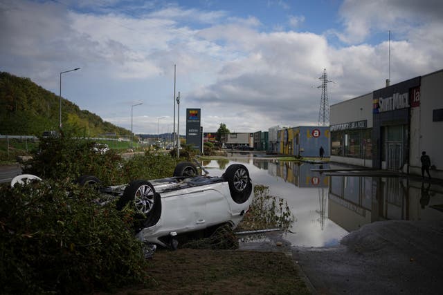 An overturned car in a car park in France after heavy rain