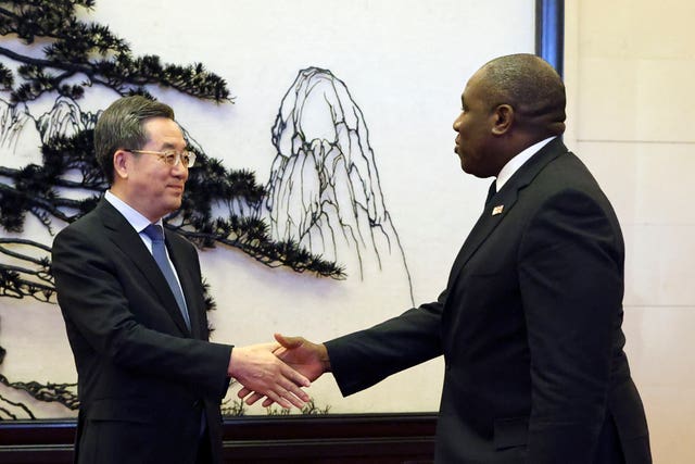 Britain’s Foreign Secretary David Lammy, right, and Chinese Vice Premier Ding Xuexiang shake hands before their meeting at the Great Hall of the People in Beijing Friday, Oct. 18, 2024