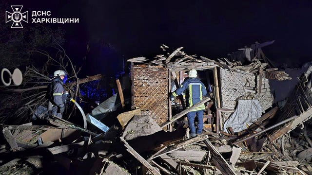 Rescue workers clear the rubble of a house destroyed by a Russian strike in Kharkiv