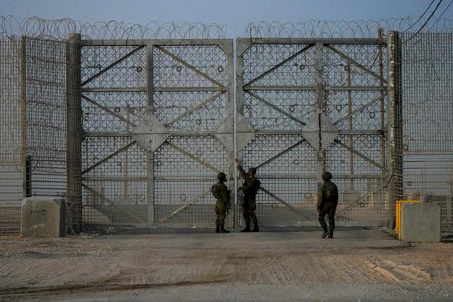 Israeli soldiers close the gate of Erez Crossing after trucks carrying humanitarian aid entered the Gaza Strip,