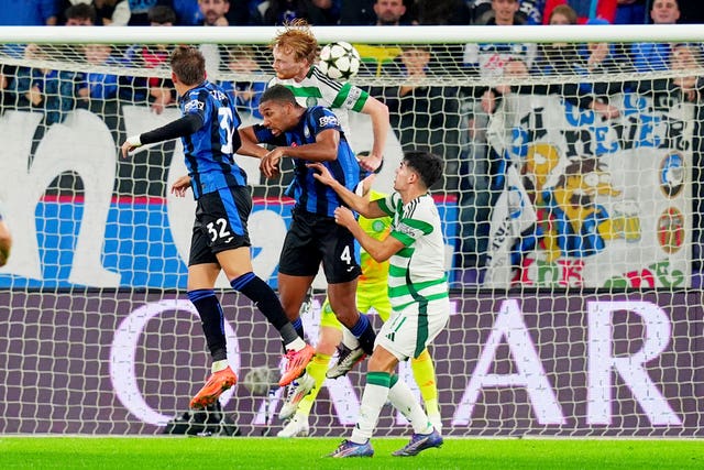 Isak Hien, centre, challenges for a header in the box