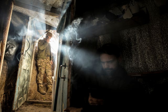 Ukrainian servicemen of the 24th Mechanised Brigade rest on their position in Chasiv Yar, Donetsk