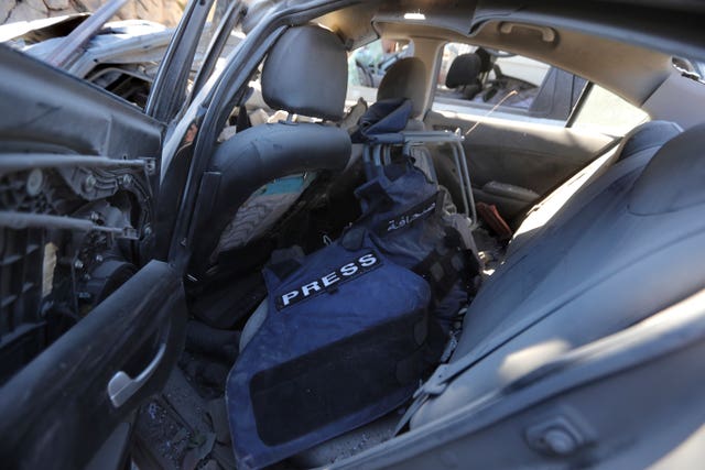 Journalists' flack jackets left inside a destroyed car, at the site 