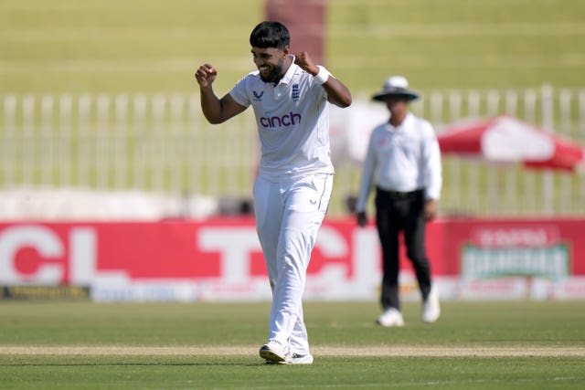 England spinner Rehan Ahmed clenches his fist at shoulder height after taking a wicket