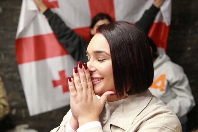 A supporter of the Coalition for Change reacts at the coalition’s headquarters after polls closing at the parliamentary election in Tbilisi, Georgia