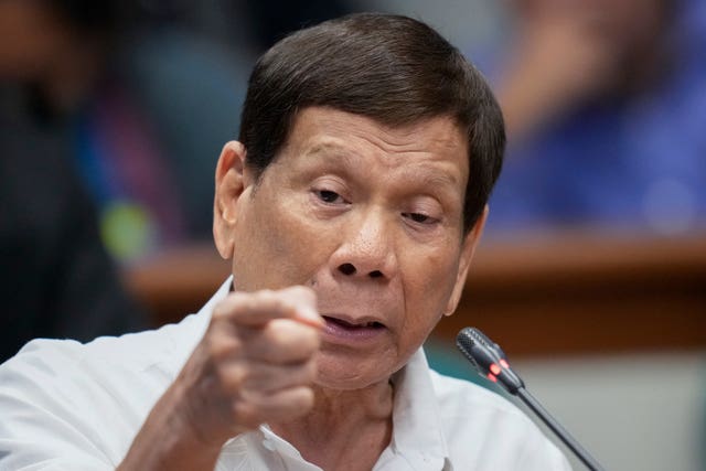 Rodrigo Duterte points at the camera