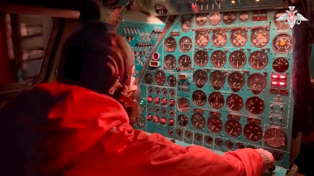 A Russian air force crew member oversees an instrument panel on board a Tu-95 nuclear-capable strategic bomber during drills of Russia’s nuclear forces