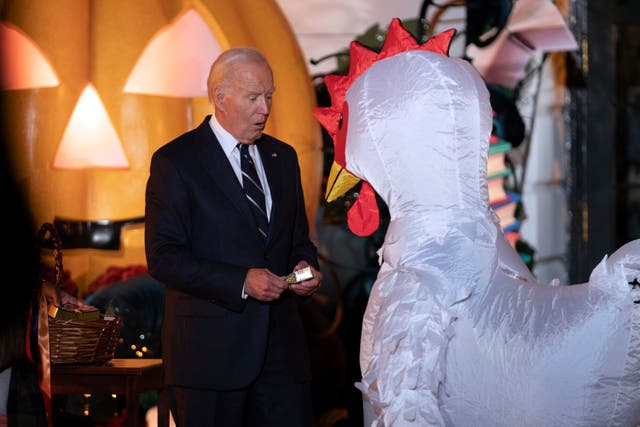 President Joe Biden gives treats to trick-or-treaters at the South Lawn of the White House