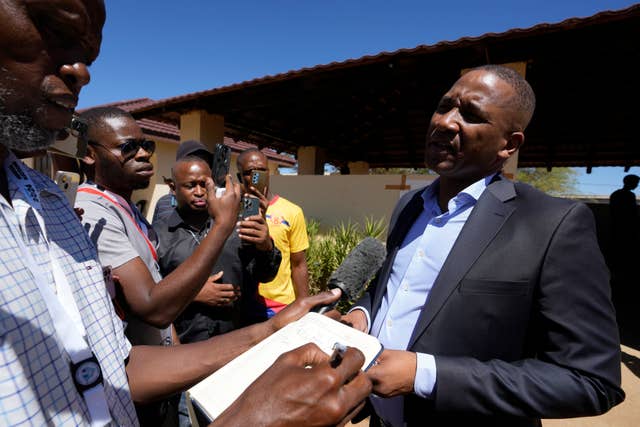 Umbrella for Democratic Change (UDC) presidential candidate Duma Boko speaks to journalist after casting his vote during the elections in Gaborone 